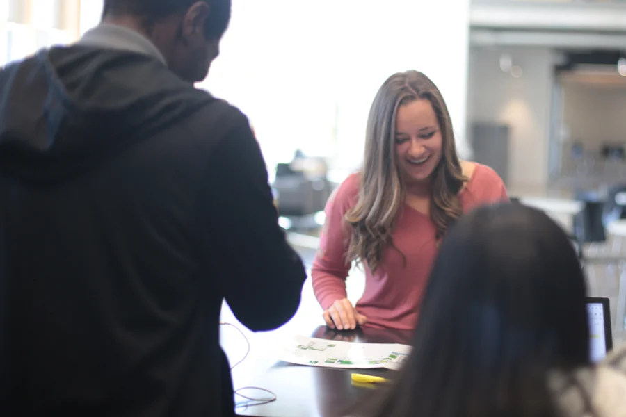Staff at O desk help visitors with finding directions.