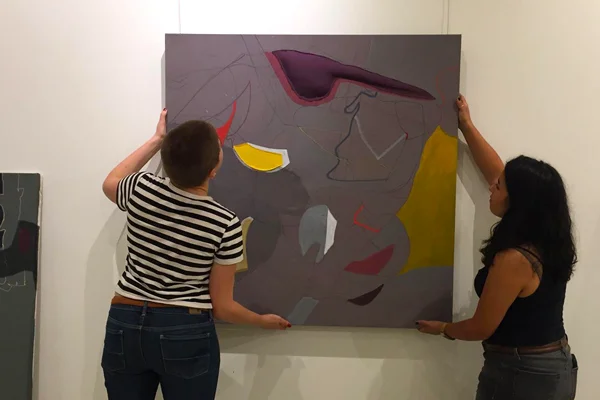 Students hanging visual art
