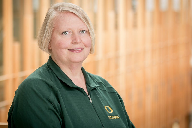 Katrina Schmidt wearing a green "O" branded pullover
