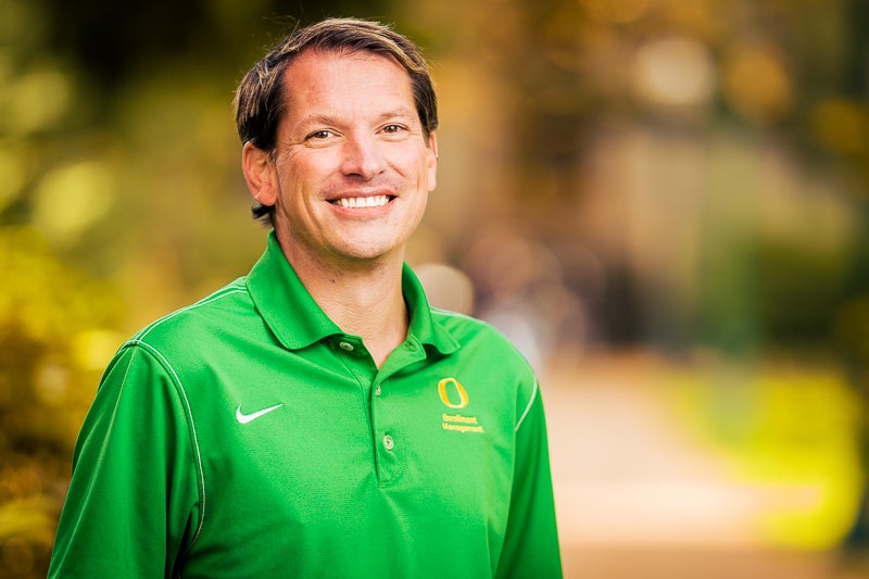 Tim Russo wearing a bright green "O" branded polo shirt