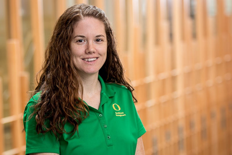 Tina Phifer wearing a bright green "O" branded polo shirt