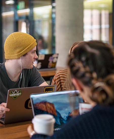 Students with laptops and coffee