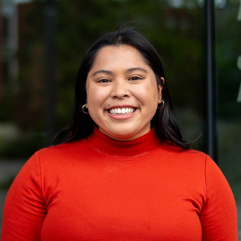 portrait of madi serrano in front of glass windows