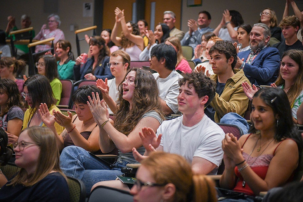 audience applauding at three minute thesis competition