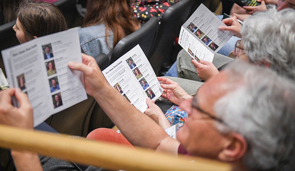 audience members reading three minute thesis programs
