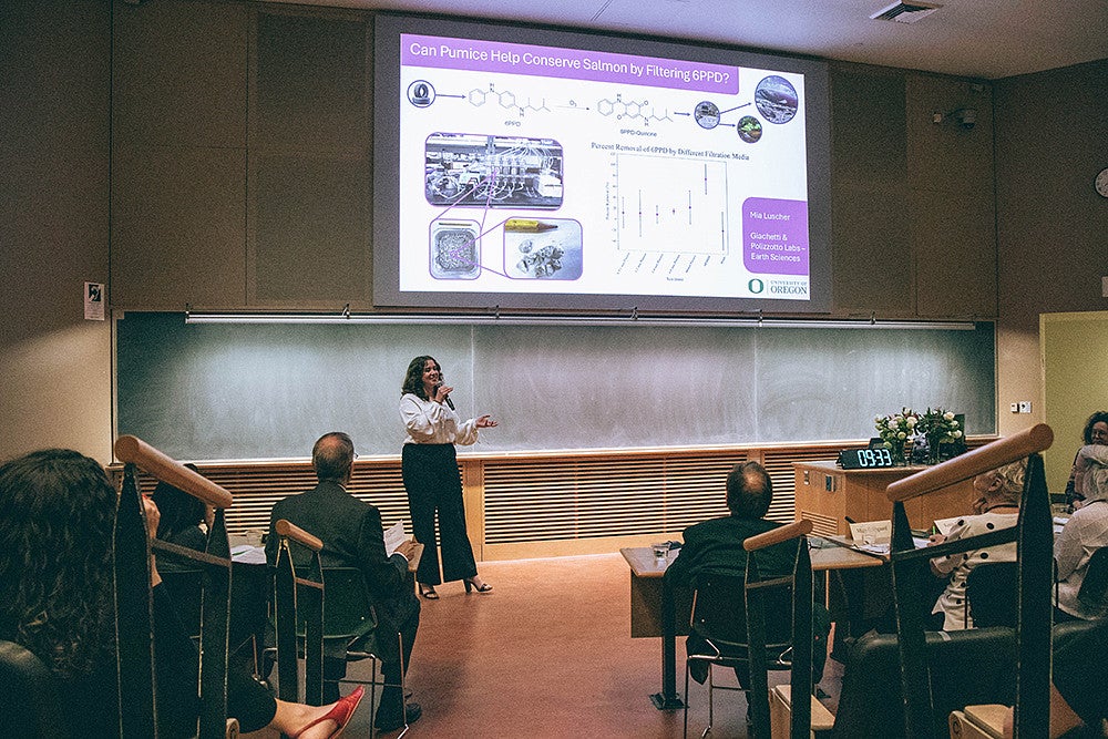 mia luscher presenting at three minute thesis competition under digital slide