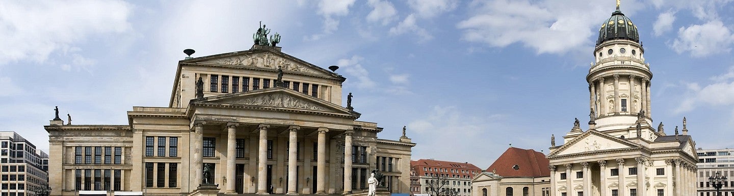 ornate greek revival buildings with columns around a square in Berlin