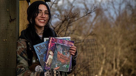 Jess Gladis holding magazines.