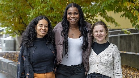 three female students posing together