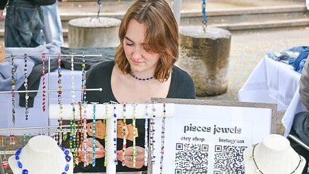 emma harris at table selling her jewelry