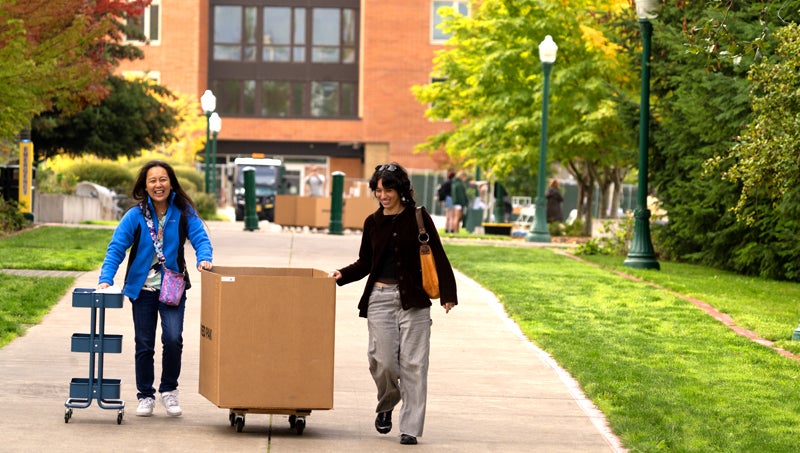 Student and parent moving belongings into the residence halls