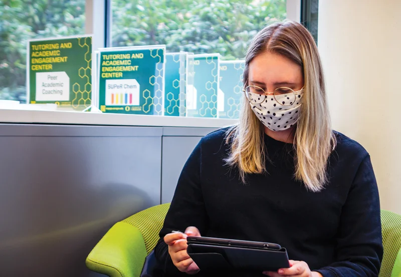 Student seated with tablet in the Academic Success Hub