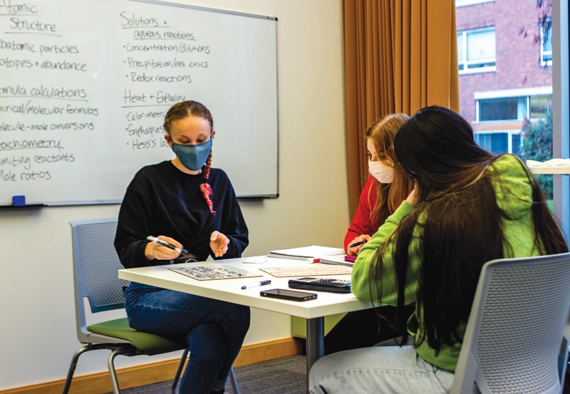 Three residents seated at table in Academic Success Hub