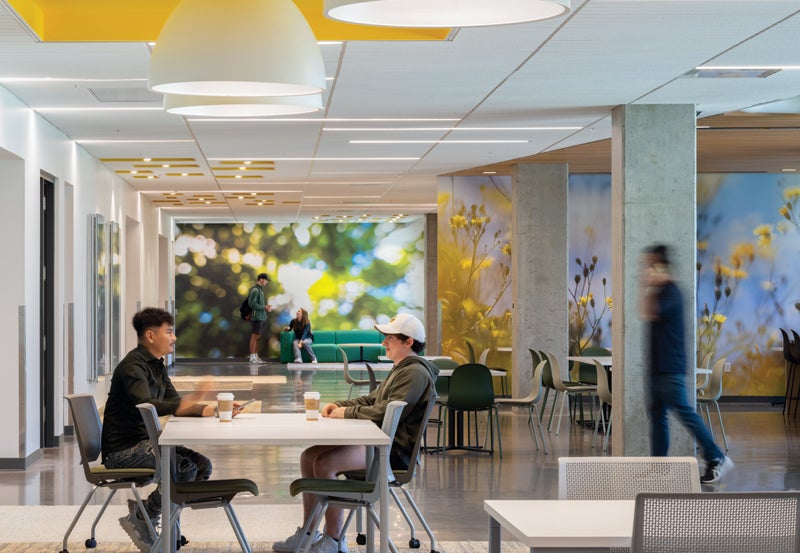 Students seated at table in community space