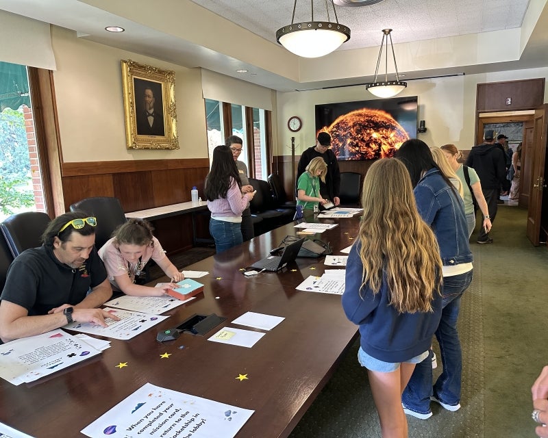 parents and kids doing projects at a conference table