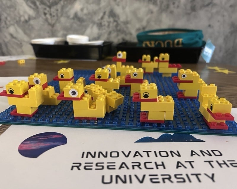 ducks made of legos on a paper that says "innovation and research at the university"