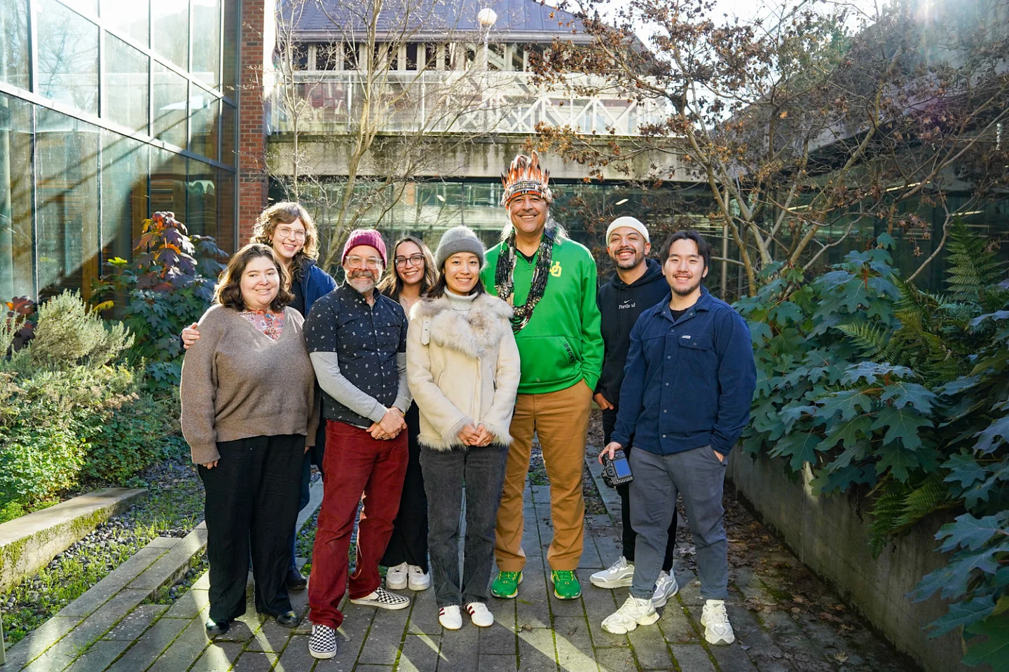 a group of people posing in an outdoor courtyard