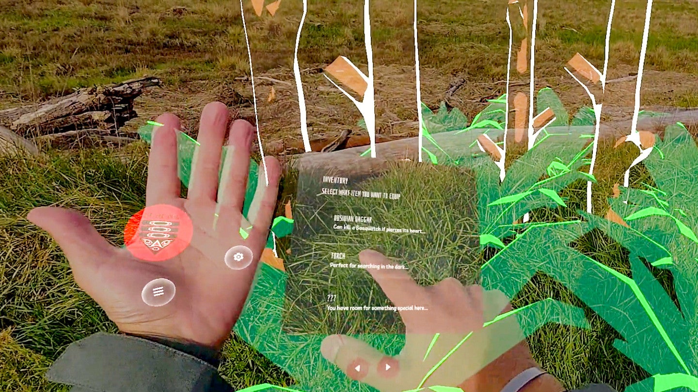 a screenshot from an augmented reality lens shows a person's real hands interacting with digital elements in a forest setting