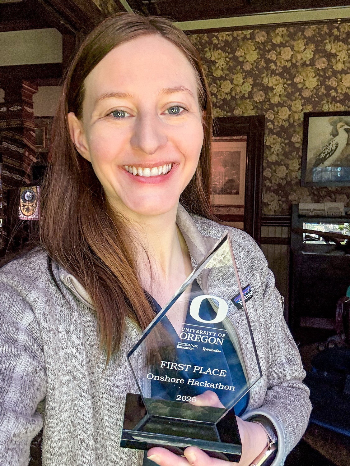 Kathleen Darby poses with her first place trophy for the OceanX Onshore Hackathon
