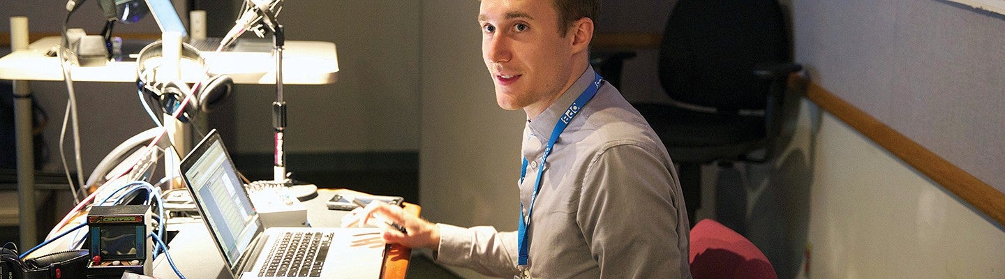 A male student woking at a computer