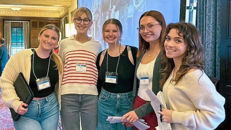 five SOJC PR students pose at a press event