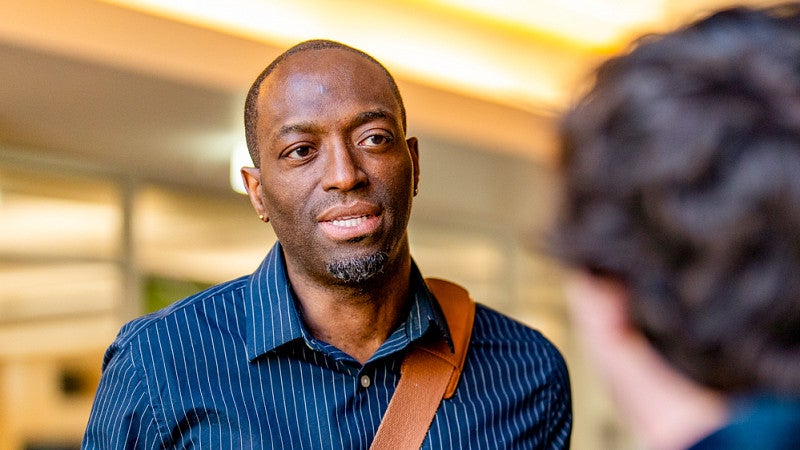 Troy Elias speaks to a student