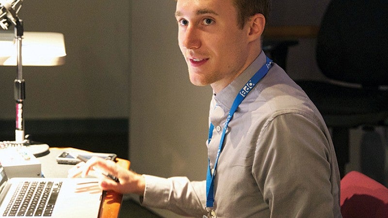 A male student woking at a computer