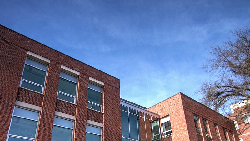the top of Allen Hall in front of a blue sky