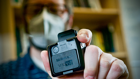 Bryce Newell holds a police body camera