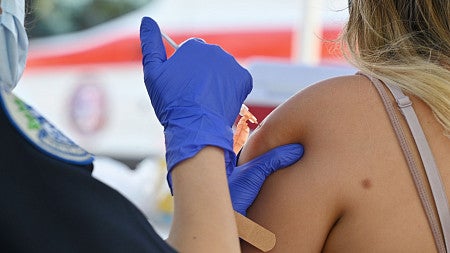 A person receives an injection