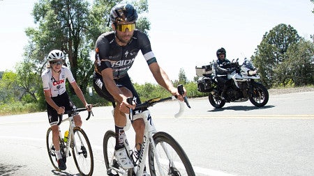 Freddy Ovett leads another cyclist in a race.