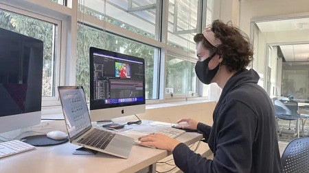 Quinn Connell works on motion graphics in the SOJC computer lab