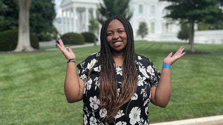 Polly Irungu stands in front of the White House