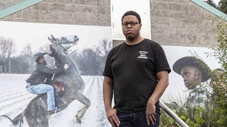Bruce Poinsette stands in front of art installation in Lake Oswego