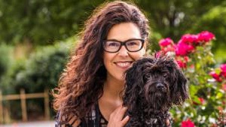 Lisa Peyton, Immersive and Strategic Communications Instructor, poses with her dog