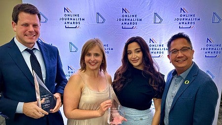 four people pose with online journalism award trophies