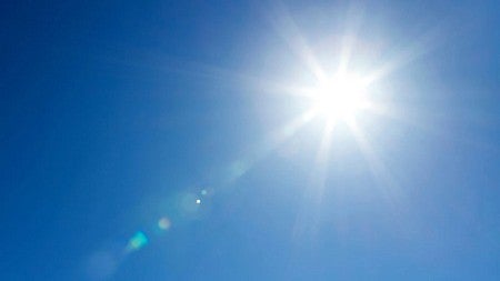 a sun flare in a blue sky