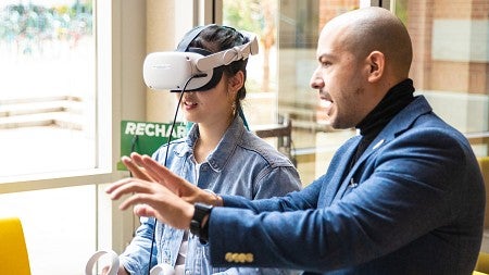 Danny Pimentel instructs a student wearing a VR headset