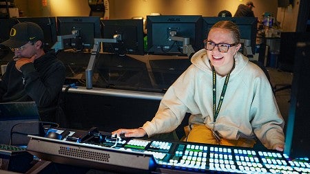 Sophie Fowler is lit by the glow of the electronic control board she sits in front of