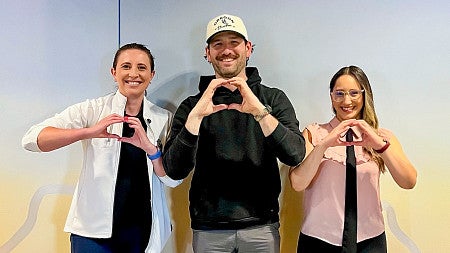 three people holding their hands in the shape of Os