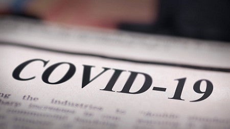 Newspaper with COVID-19 headline.