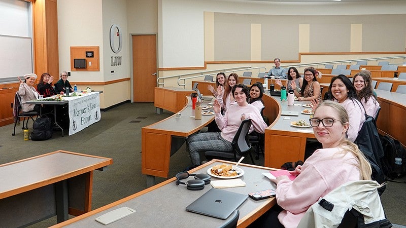 women lawyers and law students in a large lecture hall