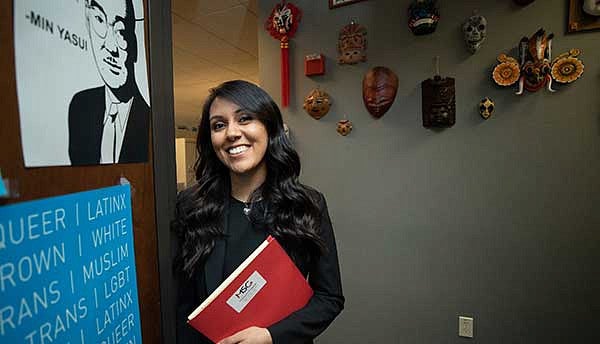 Female student next to an image of Min Yasui