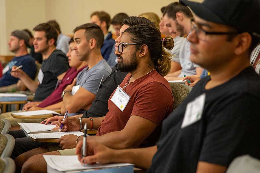 Students taking notes during a lecture