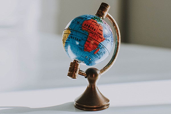 mini world globe on a white desk