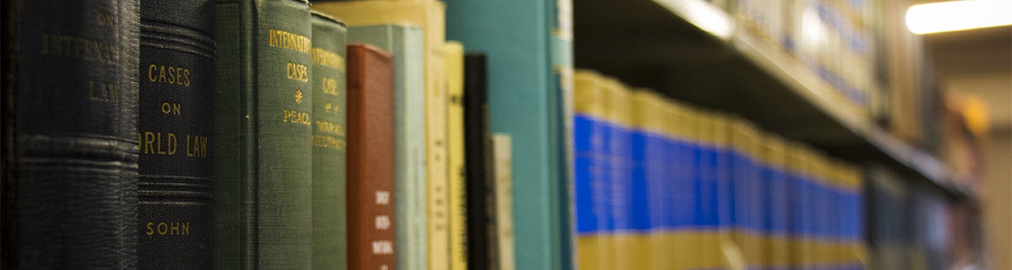 rows of books on law library shelves