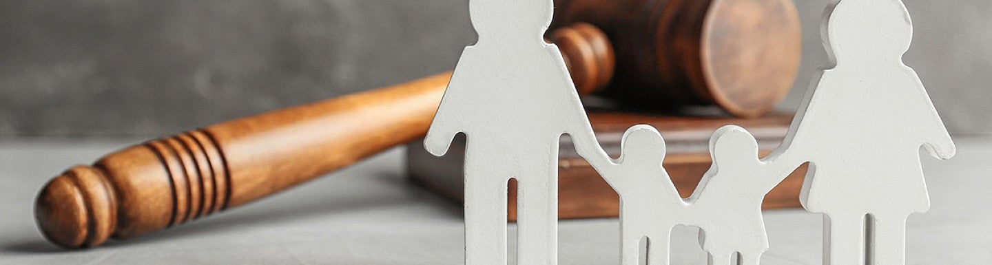 gavel with paper cutouts of a family