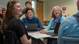 Smiling professor and students.