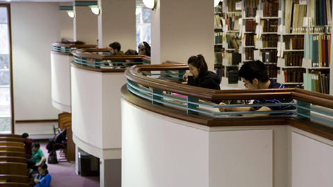 Students working at tables overlooking a mezzanine.