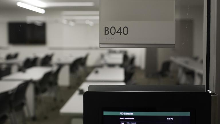 View through glass wall into empty classroom